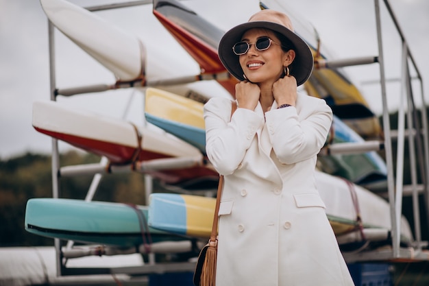 Young attractive woman in white jacket walking outdoors