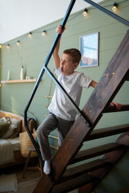 Free photo young autistic boy spending time at home indoors