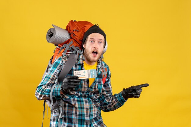 young backpacker with black hat holding air ticket