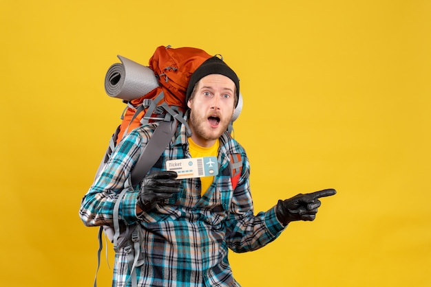 young backpacker with black hat holding air ticket