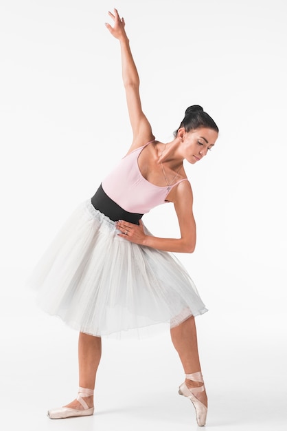 Young ballet dancer dancing in front of white backdrop