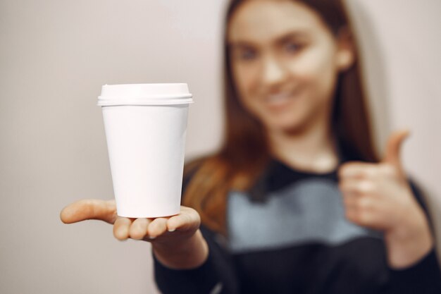 Young barista girl makes coffee and smiles