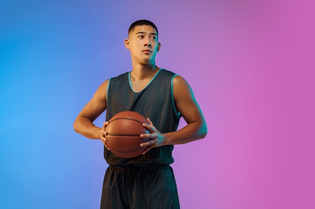 Young basketball player in neon light Free Photo