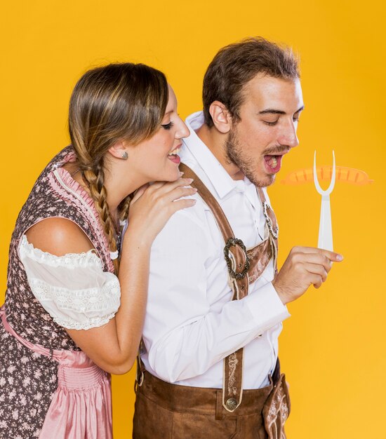 Young bavarian friends with grill fork