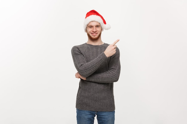 Young beard man in sweater enjoy playing and pointing finger at side