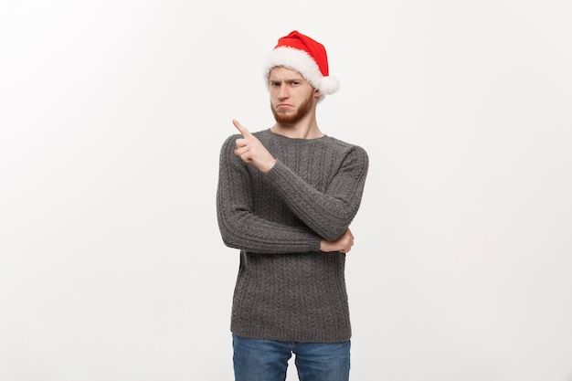 Young beard man in sweater enjoy playing and pointing finger at side