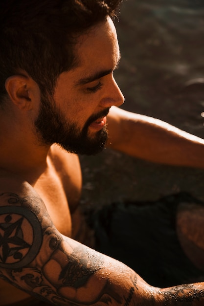 Young bearded guy with tattoo