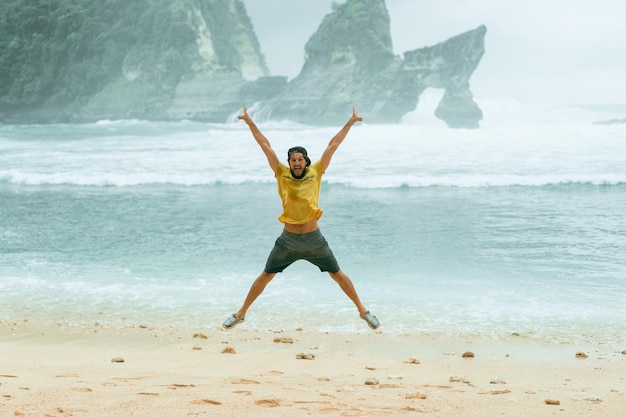 young bearded male traveler on the ocean