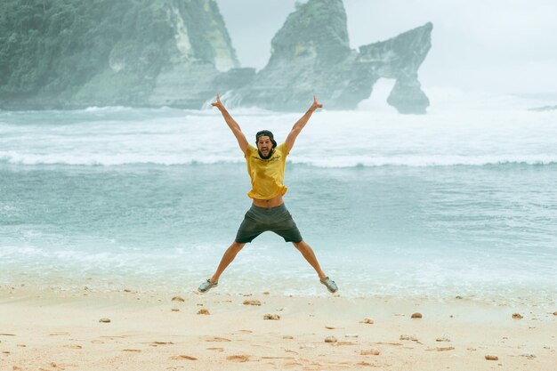 young bearded male traveler on the ocean