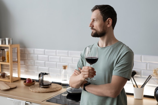 Young bearded man drinking wine