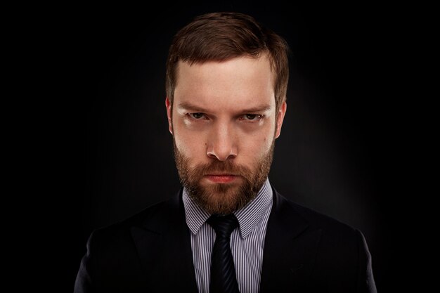 Young bearded man wearing formal suit