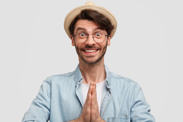 Young bearded man with round glasses and denim shirt