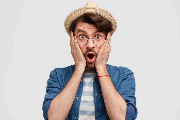 Young bearded man with round glasses and denim shirt