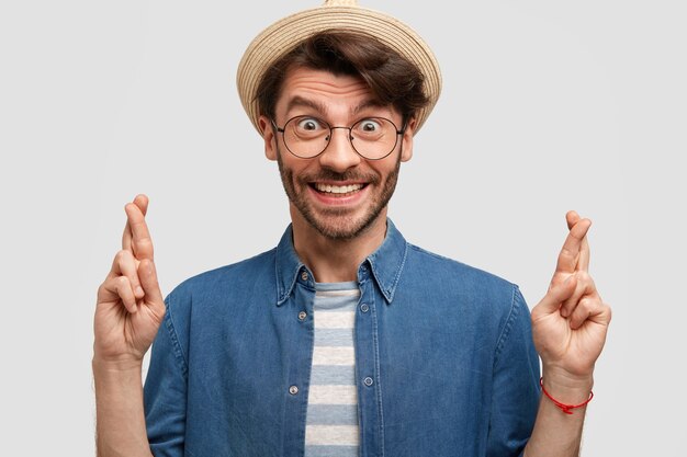 Young bearded man with round glasses and denim shirt