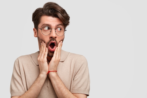 Young bearded man with round glasses