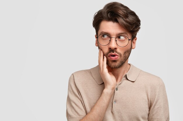 Young bearded man with round glasses