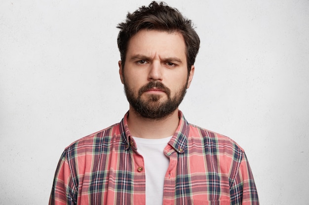 Free photo young bearded man with striped shirt