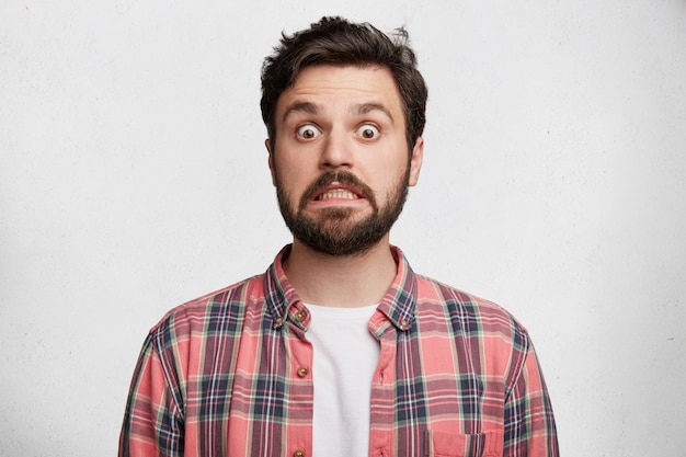 Free photo young bearded man with striped shirt