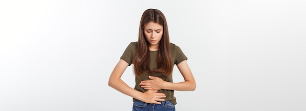 Young beautiful asian woman having painful stomachache on white background