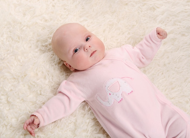 Free photo a young and beautiful baby in pink