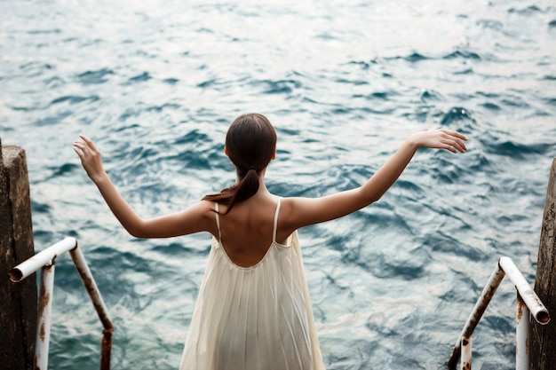 Young beautiful ballerina dancing and posing outside