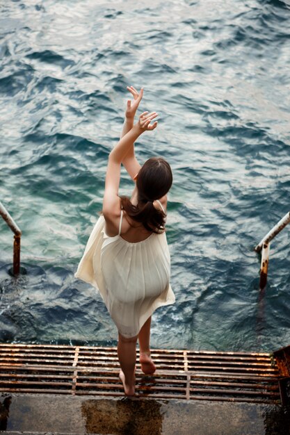 Young beautiful ballerina dancing and posing outside