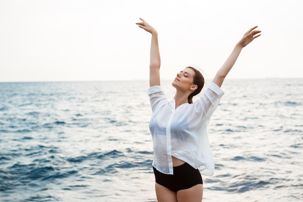 Young beautiful ballerina dancing and posing outside