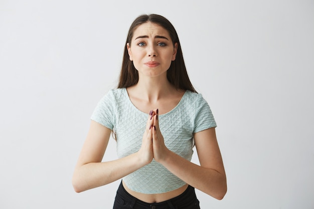 Free photo young beautiful brunette girl praying hoping .