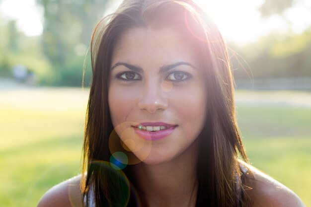 Young beautiful brunette woman having fun at the park