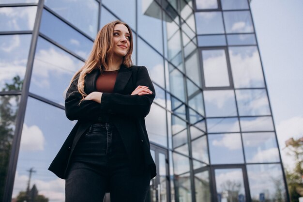 Young beautiful business woman by the office center