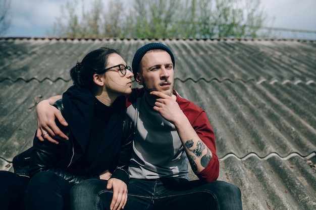 Young beautiful couple on the house roof