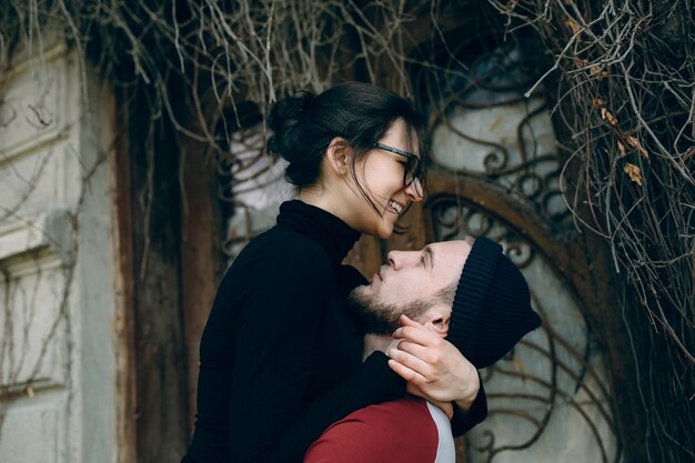 Young beautiful couple posing over an old building