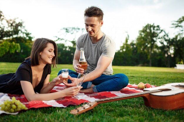 Young beautiful couple resting at park