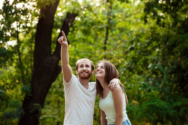 Young beautiful couple resting, walking in park, smiling, rejoicing.