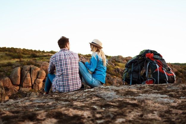 Young beautiful couple of travelers enjoying view of canyon, smiling