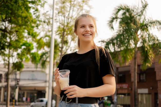 Young beautiful cute Brazilian female drinking Somo, a Bolivian drink