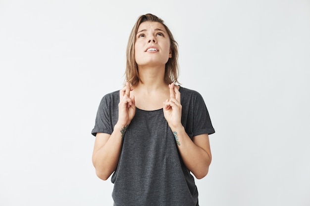 Young beautiful emotive girl praying looking up .