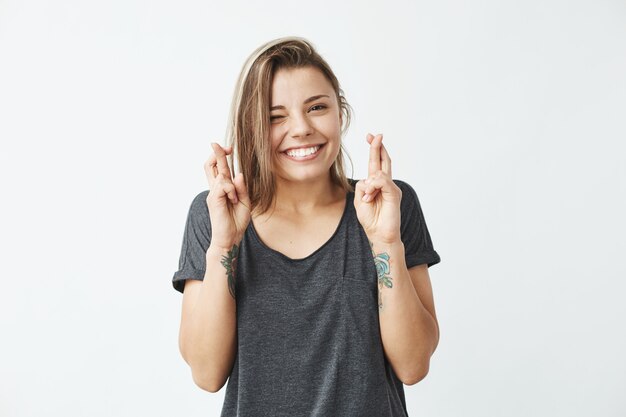 Young beautiful emotive girl smiling winking praying .