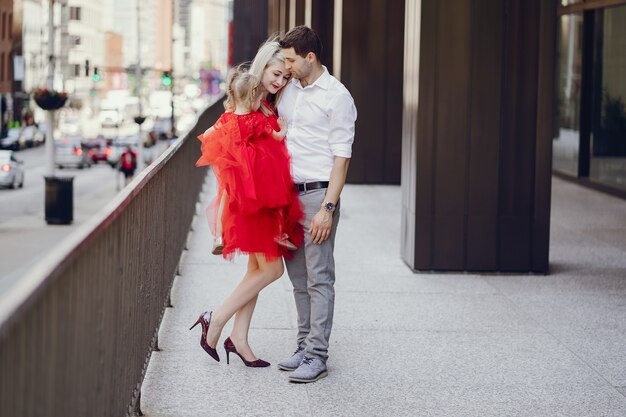 young beautiful family walking around the city with her daughter