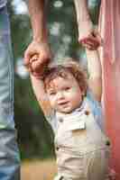 Free photo young beautiful father, mother and little toddler son outdoors