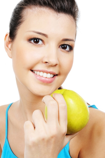 Free photo young beautiful female face with green apple - close-up