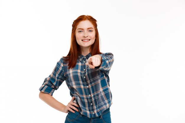 Free photo young beautiful ginger girl over white wall.