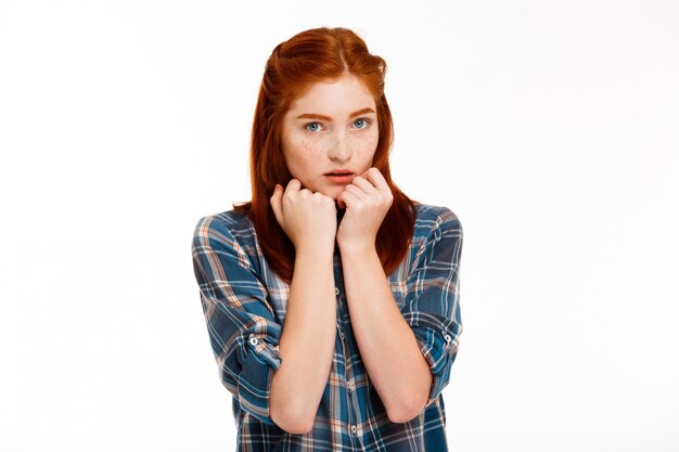 young beautiful ginger girl over white wall.