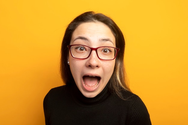 Free photo young beautiful girl in a black turtleneck shouting happy and excited