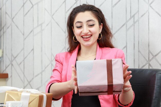 Young beautiful girl holding present box High quality photo