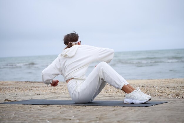 The young beautiful girl laying on the yoga mat and shaking her body High quality photo