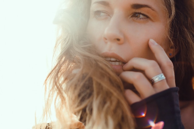 young beautiful girl posing on the beach, ocean, waves, bright sun and tanned skin