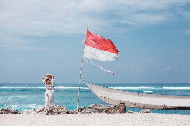 young beautiful girl posing on the beach, ocean, waves, bright sun and tanned skin