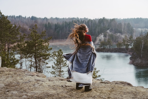 Young beautiful girl posing on a lake