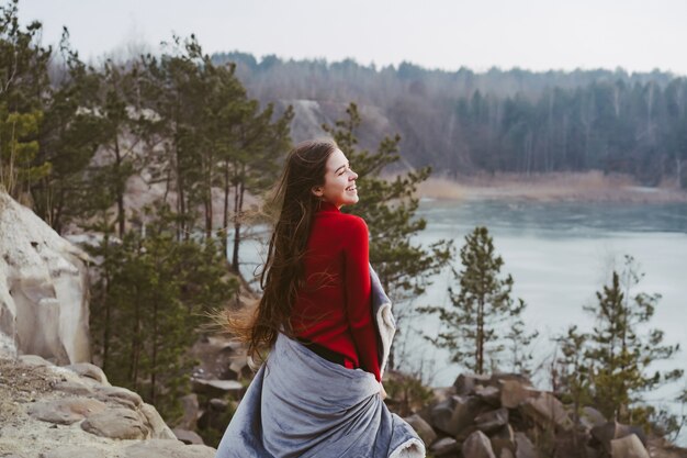 Young beautiful girl posing on a lake